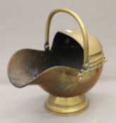 A Victorian brass coal scuttle.