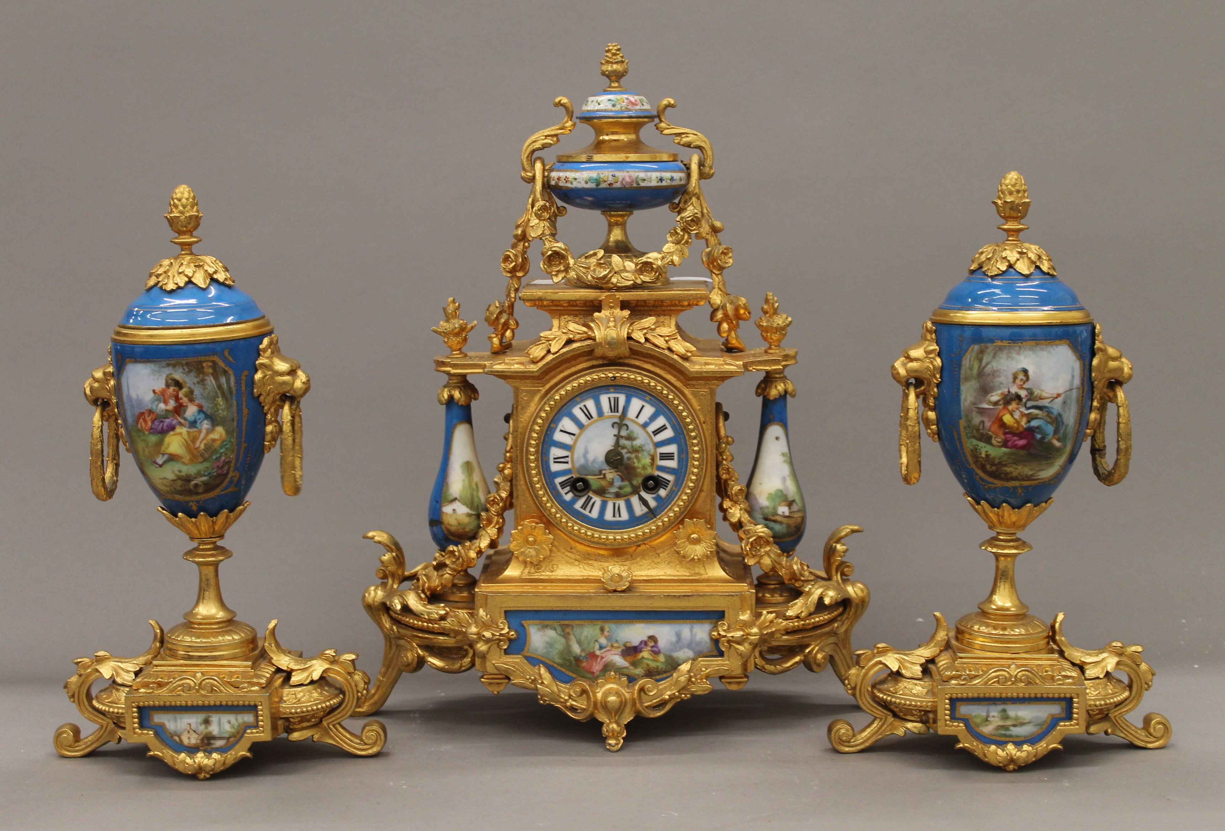 A 19th century gilt and painted porcelain three-piece clock garniture. The clock 37 cm high.