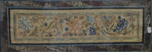 A Chinese embroidered sleeve panel, framed and glazed. 27 x 69 cm overall.