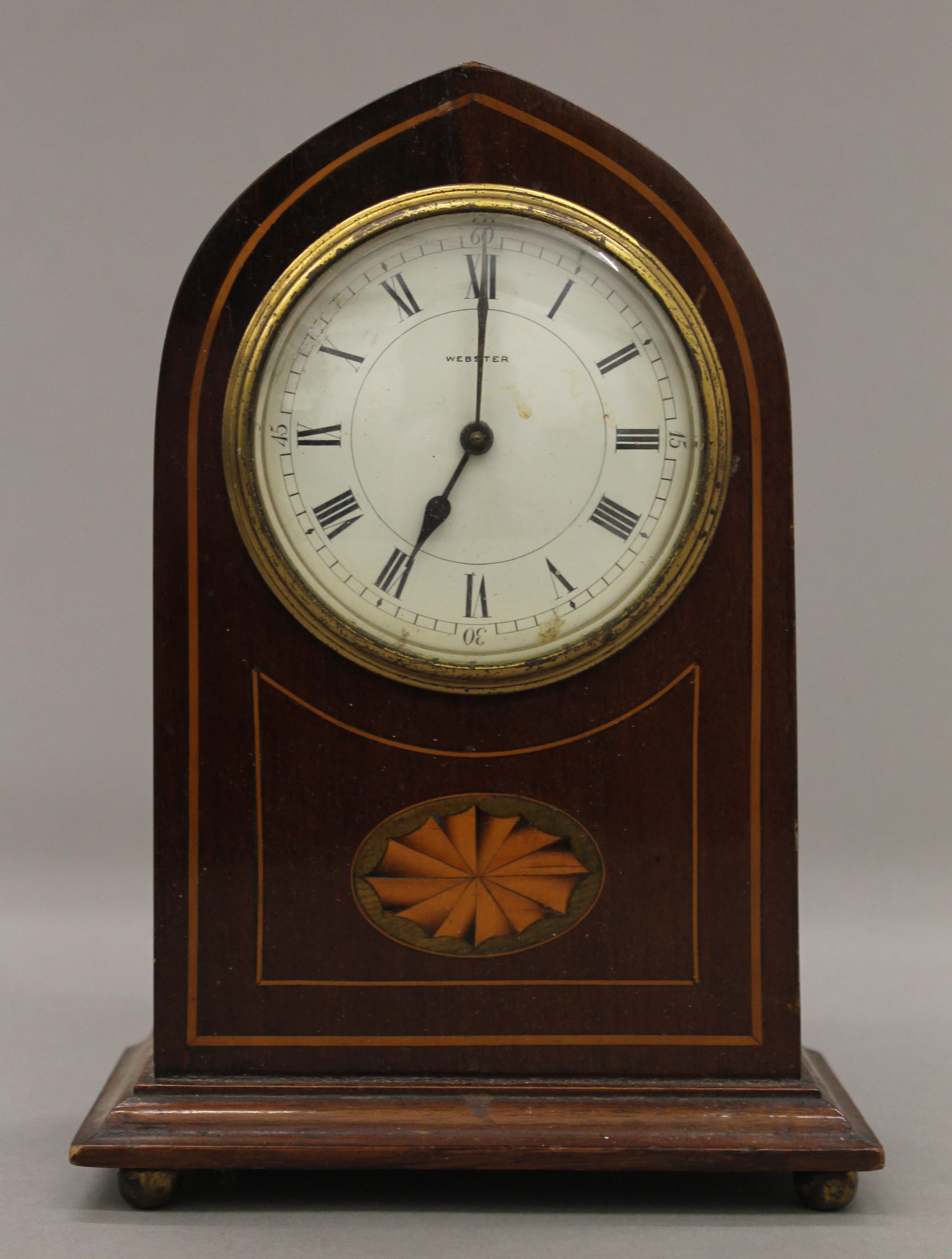 An Edwardian inlaid mahogany mantle clock. 22 cm high.
