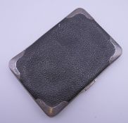 A silver and leather card case. 13 cm wide.