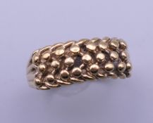 A 9 ct gold gentleman's keeper ring. Ring size X/Y. 5.8 grammes.