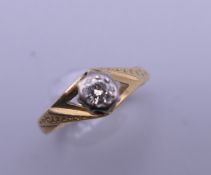 An 18 ct gold diamond solitaire ring. Ring size I/J. 2.6 grammes total weight.