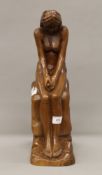 A carved wooden model of a nude female. 43 cm high.