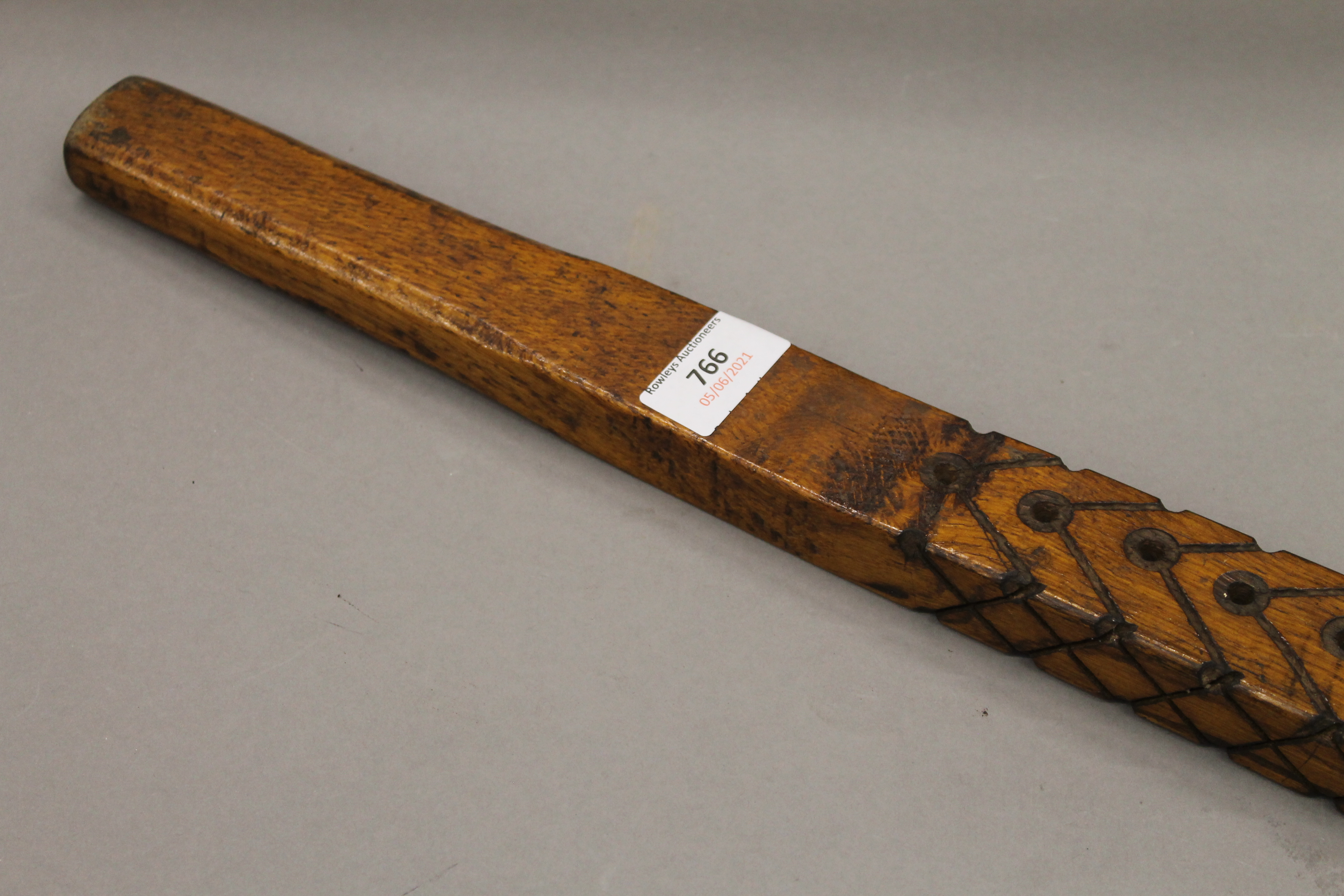 An unusual carved wooden lever/handle. 144.5 cm long.