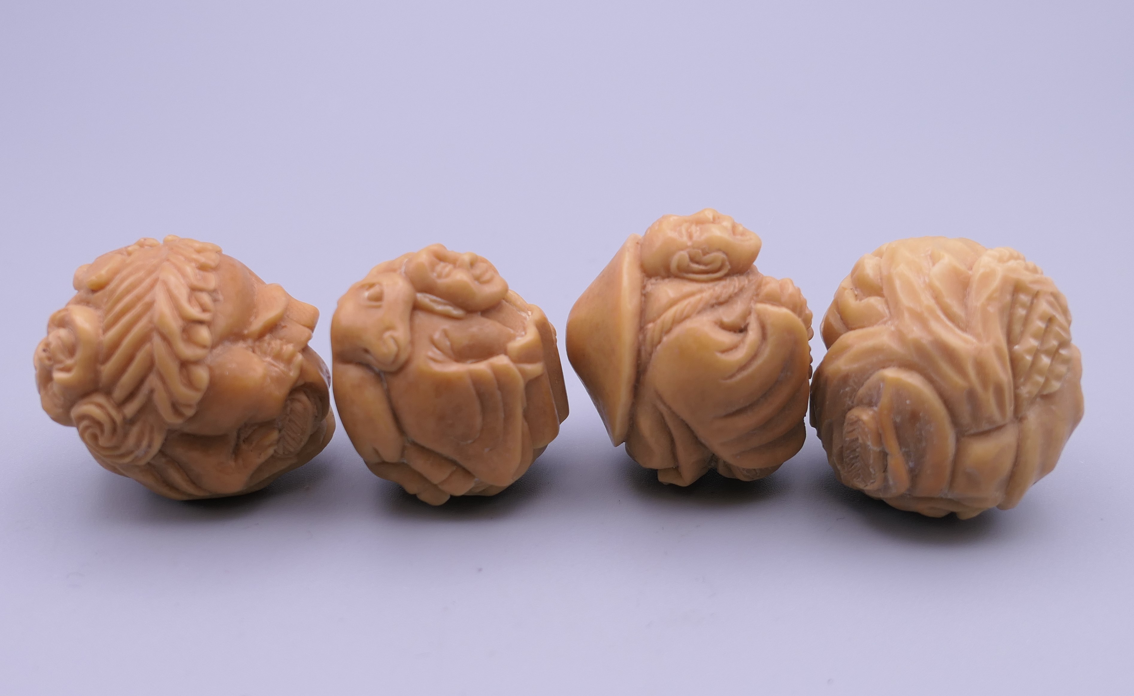 Four carved bone netsuke. Each approximately 3 cm wide. - Image 3 of 4