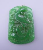 A jade pendant with a gold suspension loop. 6.5 cm high.