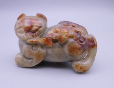 A Chinese carved jade model of a cat and a bat. 6.5 cm long.