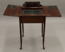 An Edwardian mahogany inlaid twin flap rising writing table. 48 cm wide closed.