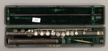 A cased rosewood two part flute. 65.5 cm long.
