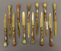 A set of porcelain handled fruit knives. Each 17.5 cm long.