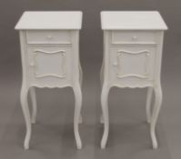 A pair of modern white painted pot cupboards. Each 40 cm wide.