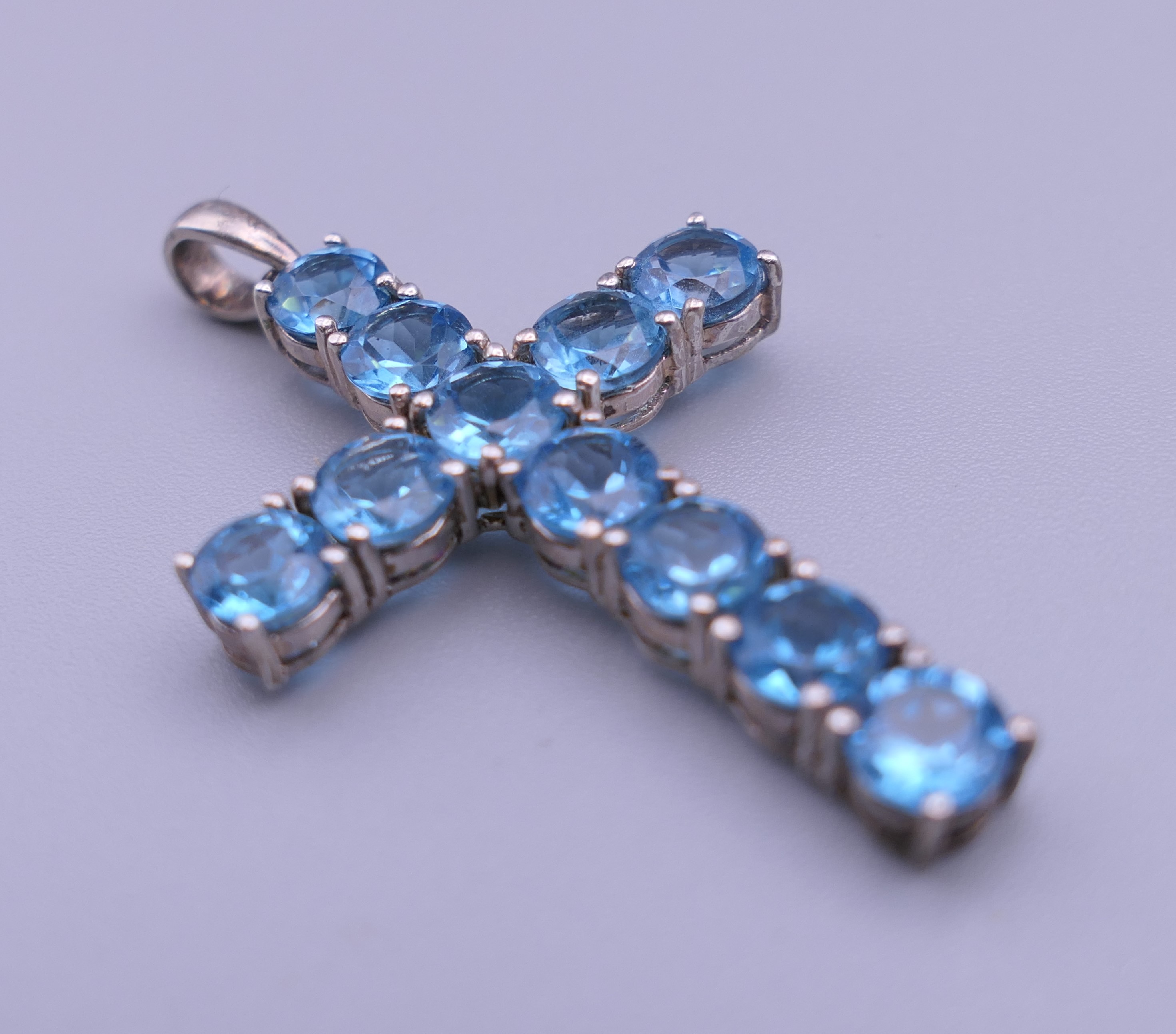 A sterling silver blue stone cross pendant, - Image 4 of 12