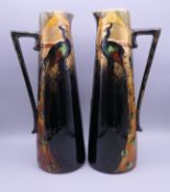 A pair of Frederick Rhead Art Nouveau pottery ewers. 30.5 cm high; 10.5 cm diameter.