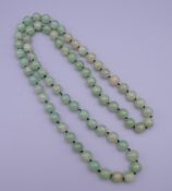 A string of jade beads. 89 cm long.