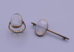 A 9 ct gold moonstone bar brooch (5.25 cm wide) and a 9 ct gold moonstone ring (ring size N/O). 11.
