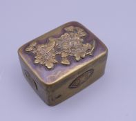 A Japanese Meiji period brass snuff box. 5 cm wide.