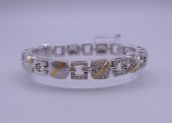 An 18 ct white gold and diamond bracelet. 18 cm long. 42.9 grammes total weight.