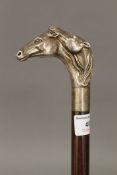 A 925 silver handled walking stick formed as two horse heads. 92.5 cm long.