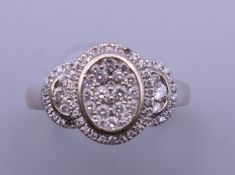 An 18 ct white gold diamond set ring. Ring size L/M. 5.4 grammes total weight.