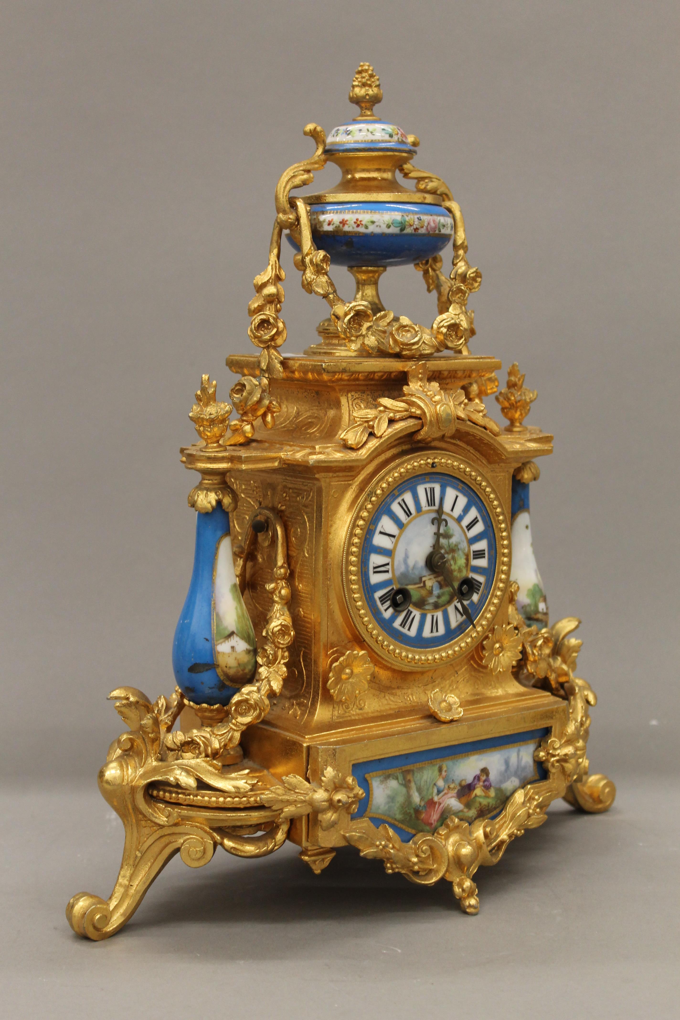 A 19th century gilt and painted porcelain three-piece clock garniture. The clock 37 cm high. - Image 4 of 11
