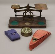 A set of scales, a cased set of scissors, a stud box and a pair of lorgnettes.