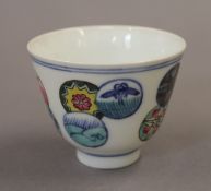 A Chinese porcelain tea bowl decorated with circular patterns. 7.5 cm diameter.