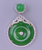 A circular jade pendant. 4.5 cm high.