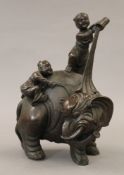 A Chinese bronze model of two boys washing an elephant. 23 cm high.