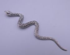 A silver marcasite snake formed pendant. 12 cm long.