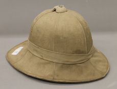 A pith helmet with wartime arrow mark.