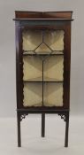 An Edwardian mahogany corner cabinet. 145 cm high.