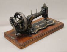 A 19th century Singer New Family sewing machine with mother-of-pearl fiddle base,