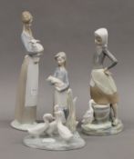 Three Lladro figures and a Nao goose group