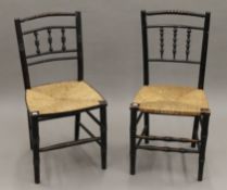 A pair of 19th century ebonised rush seated chairs. 42 cm wide.