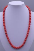 An 18 ct gold coral necklace. 48 cm long. 44.7 grammes total weight.