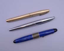 Three various fountain pens, including Sheaffer and Cross.