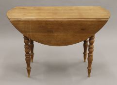 A 19th century French oak farmhouse drop leaf table. 114 cm long.