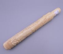 A carved bone cigar case. 23 cm long.