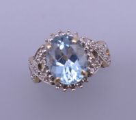 A 9 ct gold aquamarine and diamond ring. Ring size K.