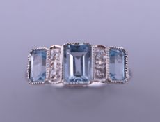 A 9 ct white gold Art Deco style aquamarine and diamond ring. Ring size N.