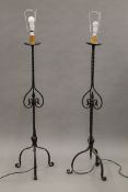 A pair of wrought iron standard lamps. 144 cm high.