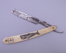 A cut throat razor with scrimshaw decoration. 16 cm long closed.