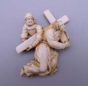 A 19th century ivory carving of Christ carrying the cross. 6.5 cm high.