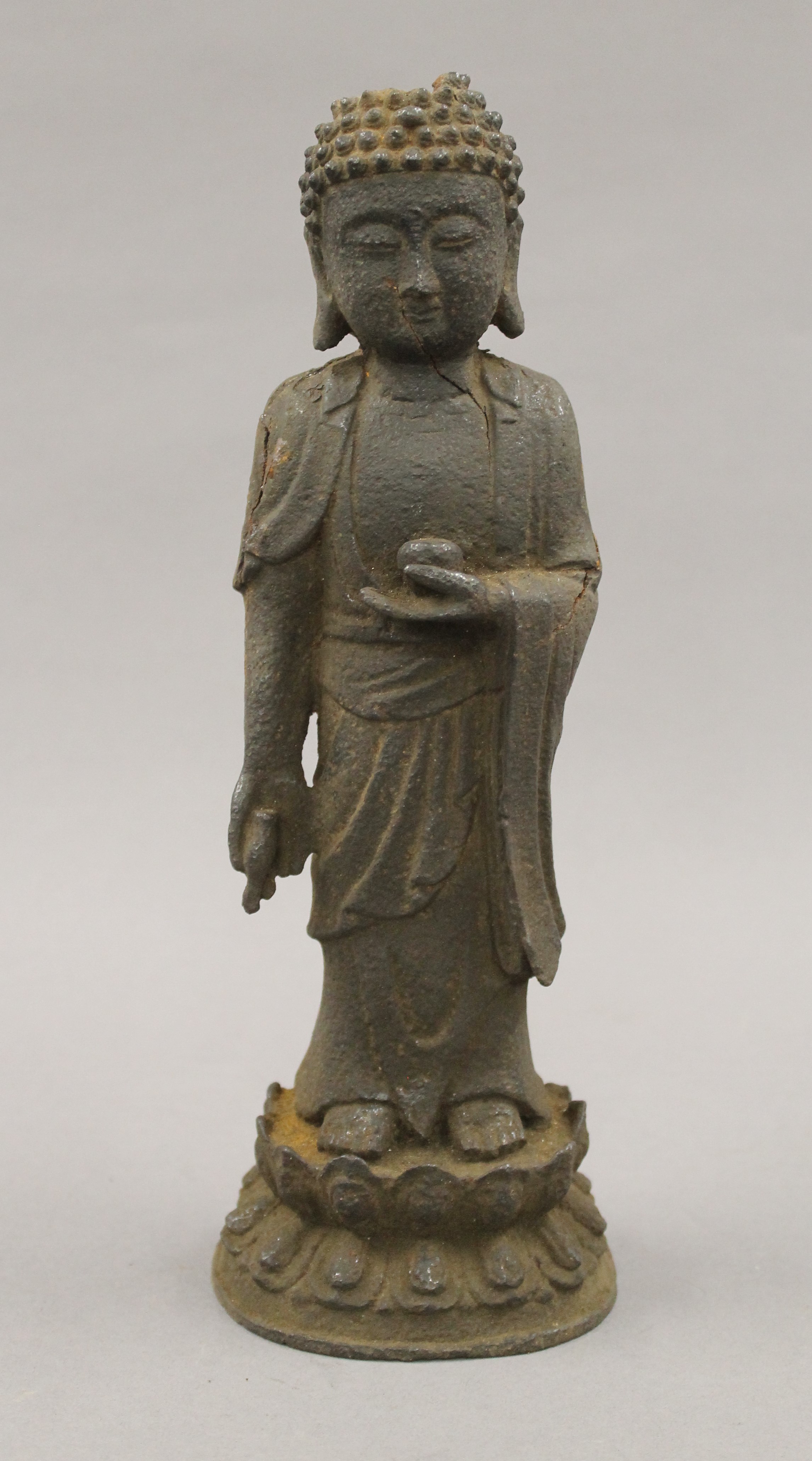 An antique Chinese iron model of buddha. 27 cm high.