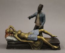 A cold painted bronze of an Arab and nude. 18 cm long.