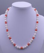 A 14 ct gold coral and pearl necklace. 41 cm long.