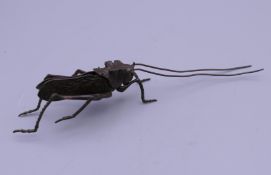 A bronze model of an articulated locust. 13.5 cm long.