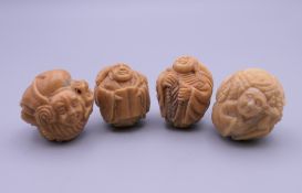 Four carved bone netsuke. Each approximately 3 cm wide.