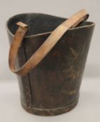 A leather bucket. 34 cm high.